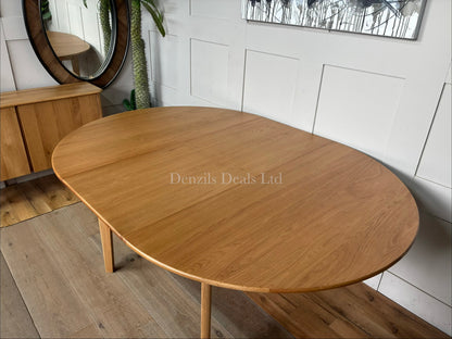 "The Wright solid oak round dining table from Fishe and Lilly, extended to its oval 6-to-8 seater configuration,