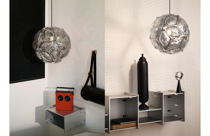 Modern Tom Dixon Puff Pendant Light in polished stainless steel with a black fabric cable, showing its unique 'inflated' geometric shade and reflective facets." Heal's and Nest often highlight its light-scattering properties.