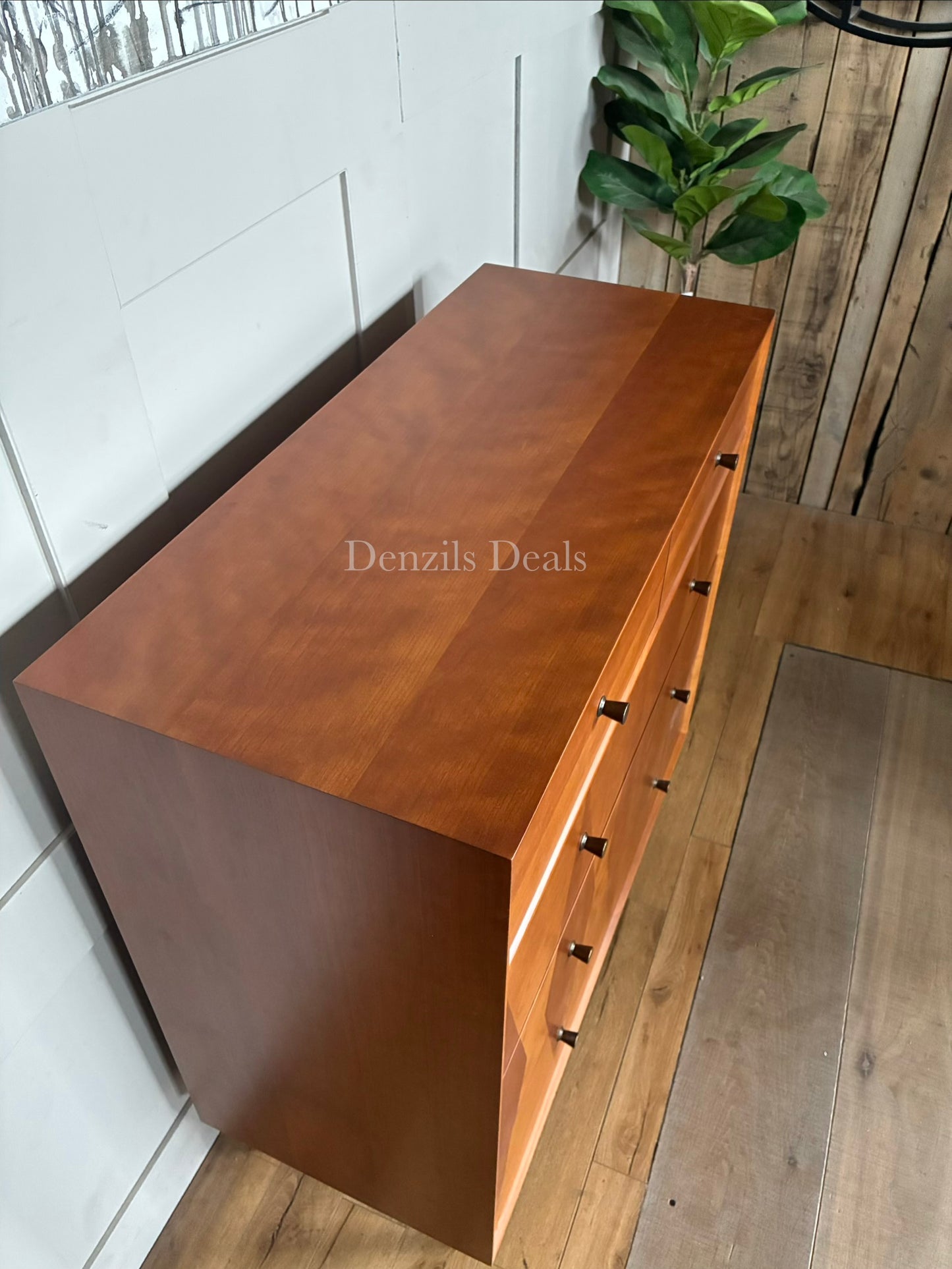 Top-view of the marquetry technique on the drawer fronts, highlighting contrasting light and dark natural wood panels."