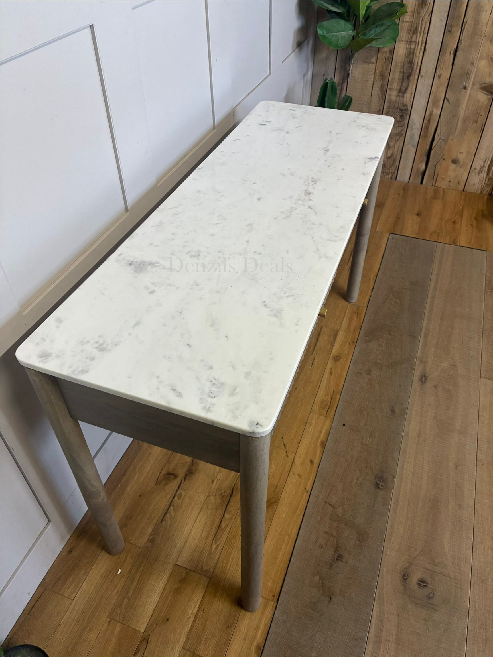 Marmo Marble Top 2 Drawer Console Table with a polished white Indian Carrera marble surface with unique grey and blue veining, Crafted from solid mango wood with a grey-wash finish, two drawers feature striking vertical ribbed textures that provide architectural depth. Finished with elegant round button knobs, typically in brass or gold-toned metal