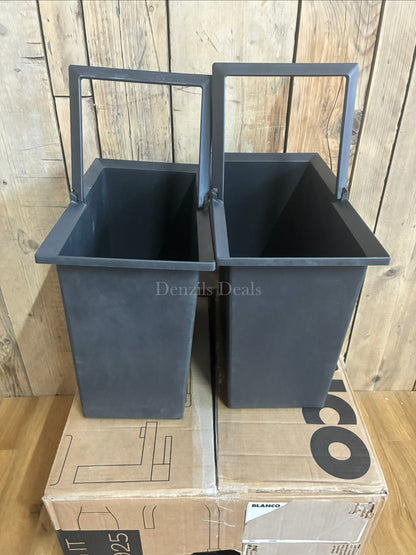 A BLANCO Select under-counter pull-out kitchen bin with two grey compartments, shown partially extended from a minimalist dark cabinet to reveal its 38-litre waste separation system. 