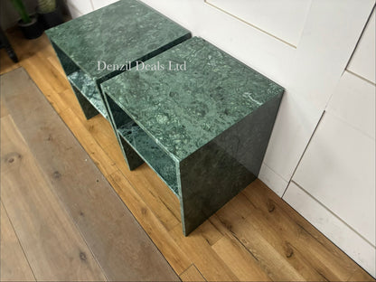 Two matching Anthropologie Gia Open Side Tables side-by-side. The tables are constructed entirely of solid, polished green marble featuring organic dark and light veining, with a minimalist, open-frame design that creates a hollow lower clearance.