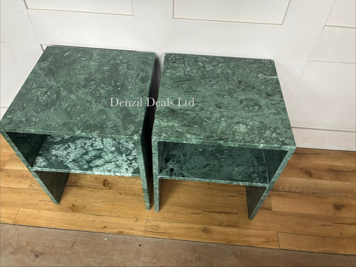Two matching Anthropologie Gia Open Side Tables side-by-side. The tables are constructed entirely of solid, polished green marble featuring organic dark and light veining, with a minimalist, open-frame design that creates a hollow lower clearance.