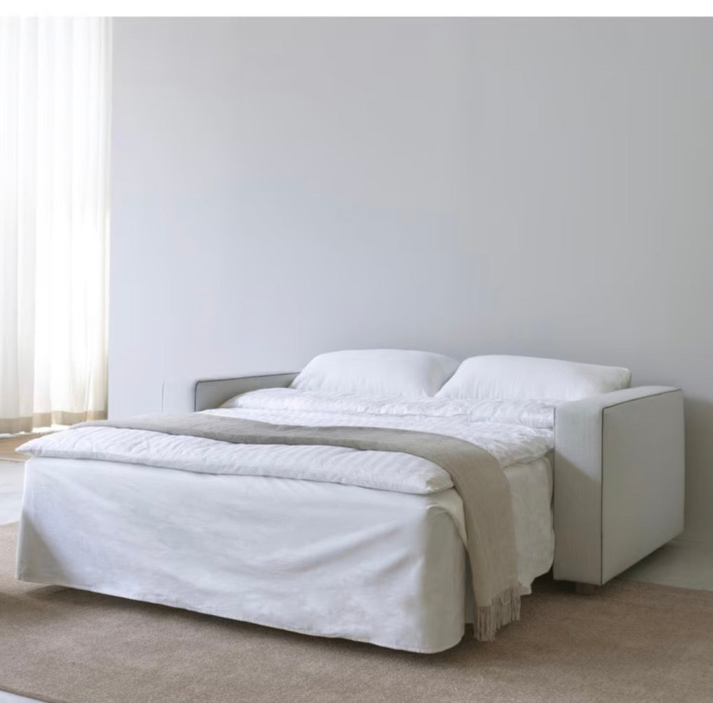 Innovation Living Neah 140 sofa bed unfolded into a double bed, showing the pocket spring and foam mattress in a natural textured fabric.