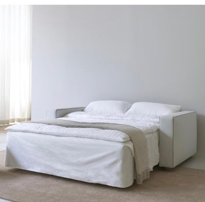 Innovation Living Neah 140 sofa bed unfolded into a double bed, showing the pocket spring and foam mattress in a natural textured fabric.