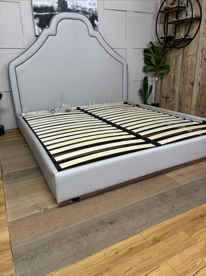 DFS Upholstered super king bed frame in a vibrant Joules hand-drawn blue ticking stripe  fabric with a dramatic tall headboard and sleek dark wood carved feet