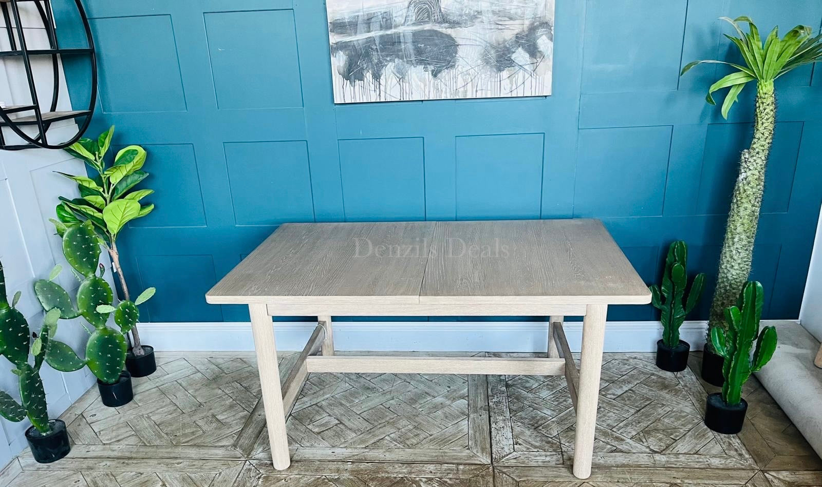 West Elm Hargrove extendable wood dining table shown fully extended, showcasing the smooth, continuous light oak veneer grain patterns and structural support underframe.