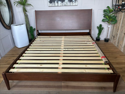 West Elm Mid-Century Wright bed frame made of solid wood in acorn, designed with low profile and support slats. Clear view on footboard 