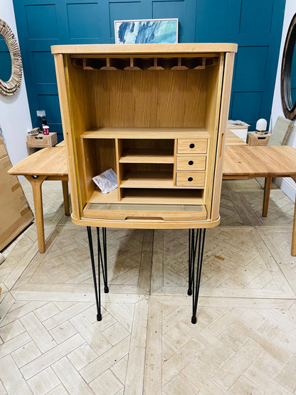 Wooden desk top storage unit with grey finish and sliding tambour doors.
