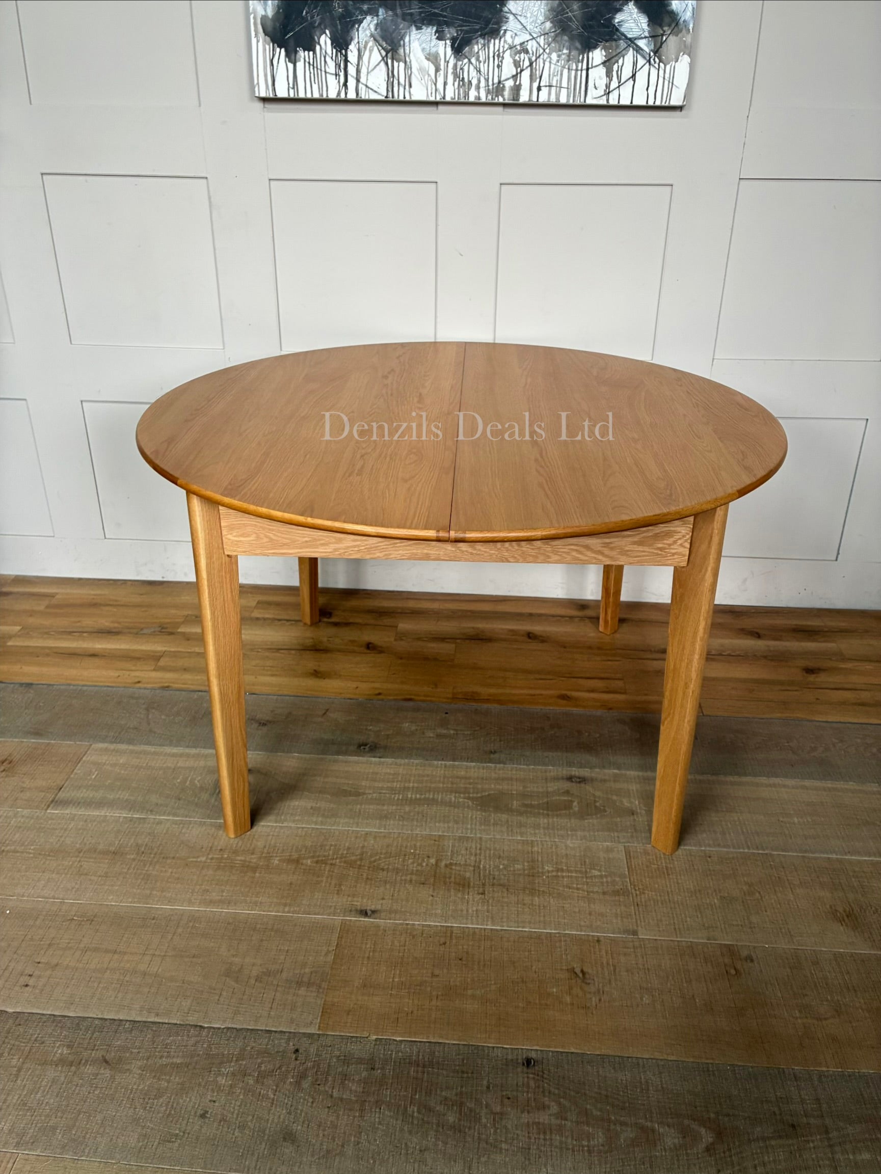 "The Wright solid oak round dining table from Fishe and Lilly, extended to its oval 6-to-8 seater configuration,