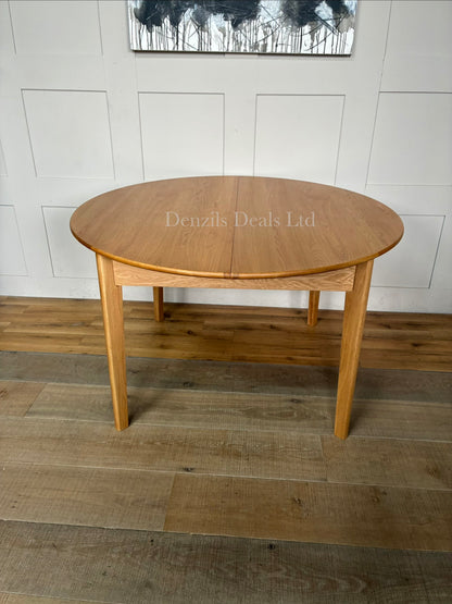 "The Wright solid oak round dining table from Fishe and Lilly, extended to its oval 6-to-8 seater configuration,