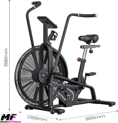 Close-up view of an athlete pushing and pulling the multi-position handlebars of an indoor air bike. The rider is focused on the onboard LCD console which tracks real-time workout metrics such as calories burned and RPM