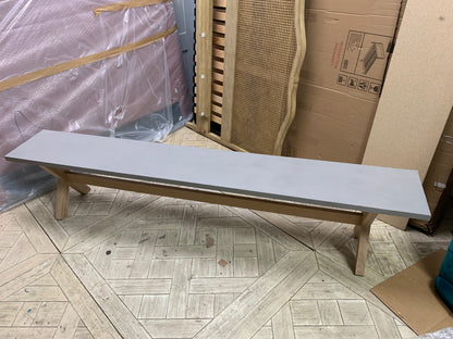  extra large Loaf Budge dining benches with grey tops and wooden legs paired with a matching kitchen dining table in a bright, modern room.
