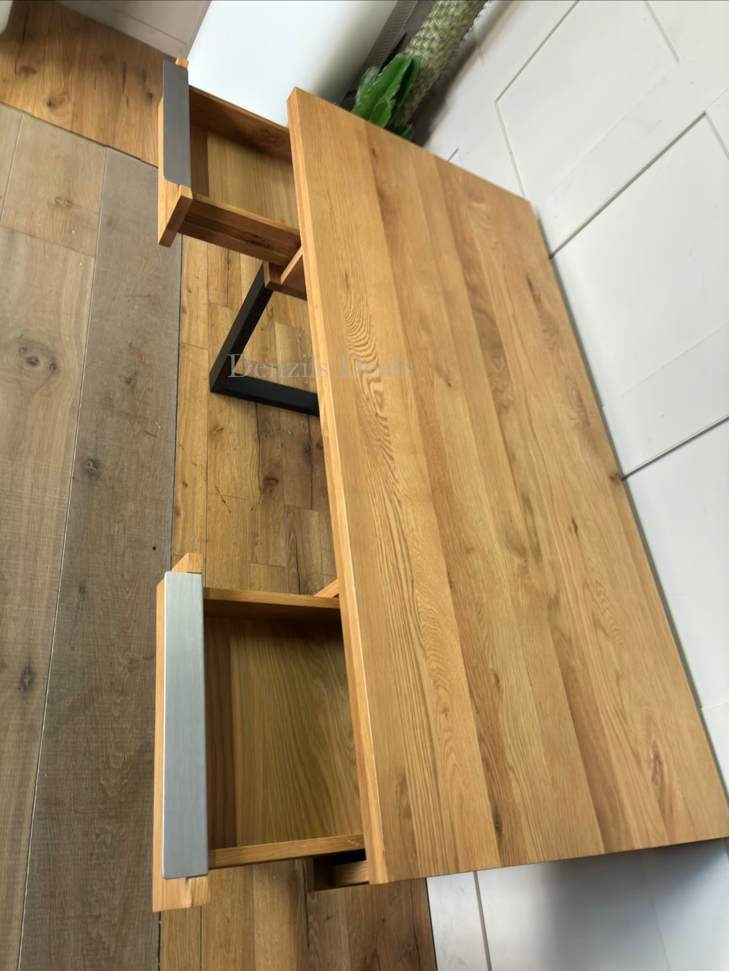 A rustic, light oak writing desk with natural wood grain and an industrial-edged welded iron base.