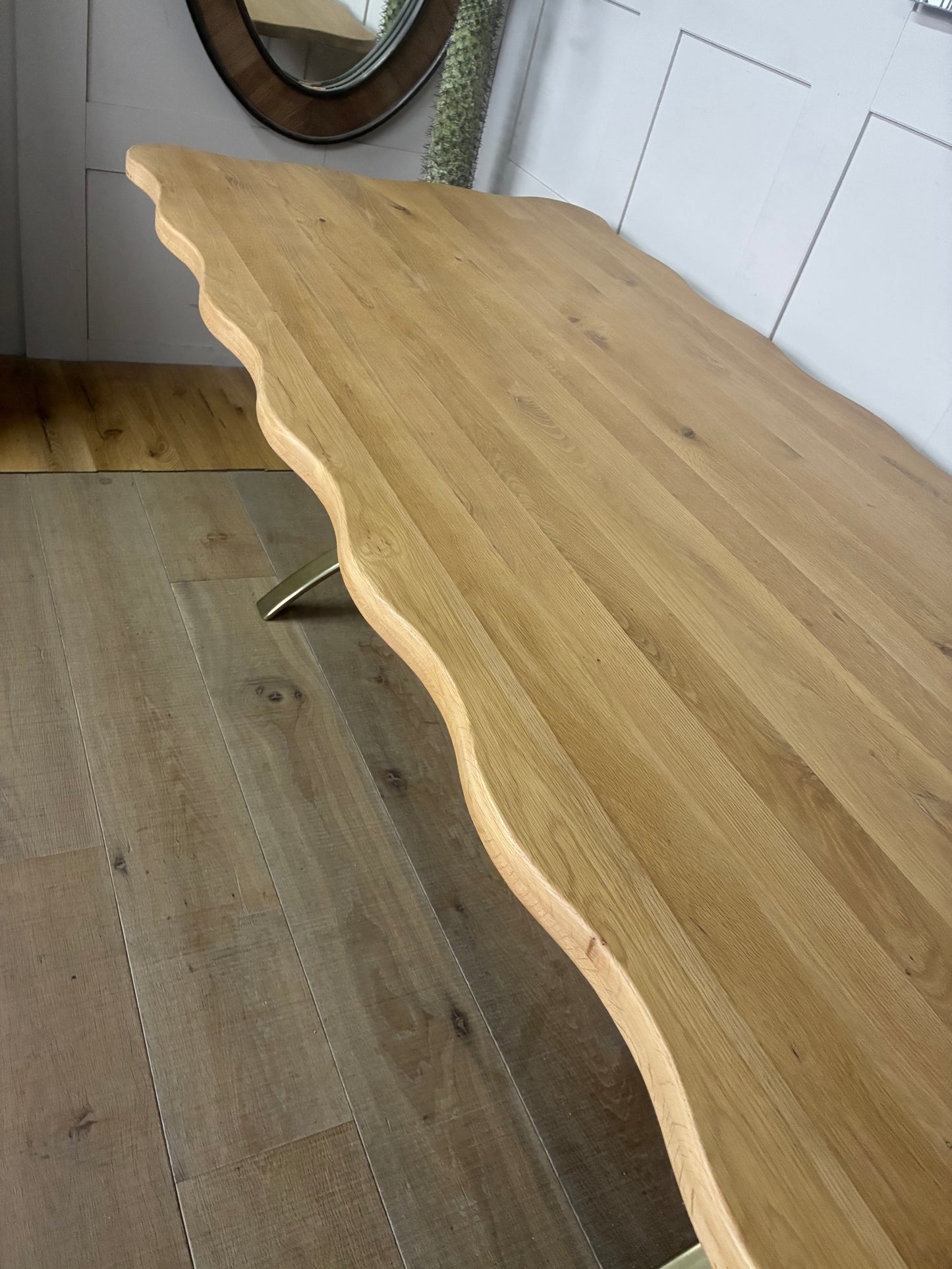A long rectangular dining table made of solid oak and tropical hardwood with a natural oak finish, showcasing a distinct light wood grain texture.