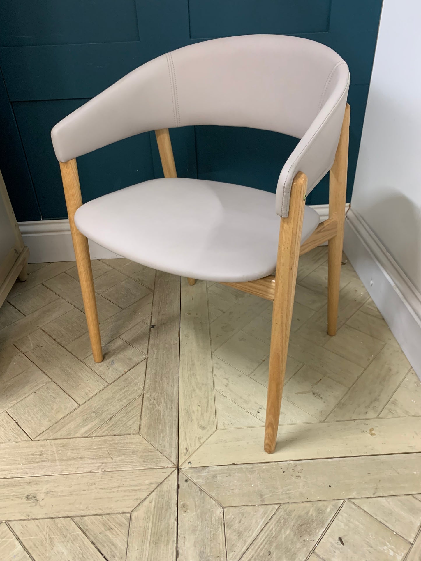 Blind Accessibility: "A rounded hospitality armchair made of solid beechwood with a comfortably padded, upholstered seat and back