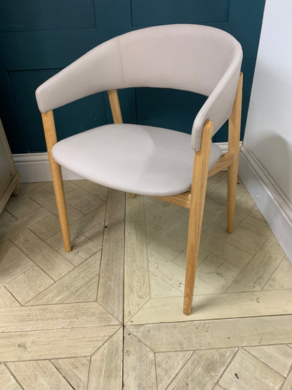 Blind Accessibility: "A rounded hospitality armchair made of solid beechwood with a comfortably padded, upholstered seat and back