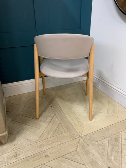 Blind Accessibility: "A rounded hospitality armchair made of solid beechwood with a comfortably padded, upholstered seat and back