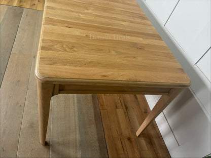 Close-up of the pale matt finish and smooth solid oak grain on the NEWTON extendable dining table."