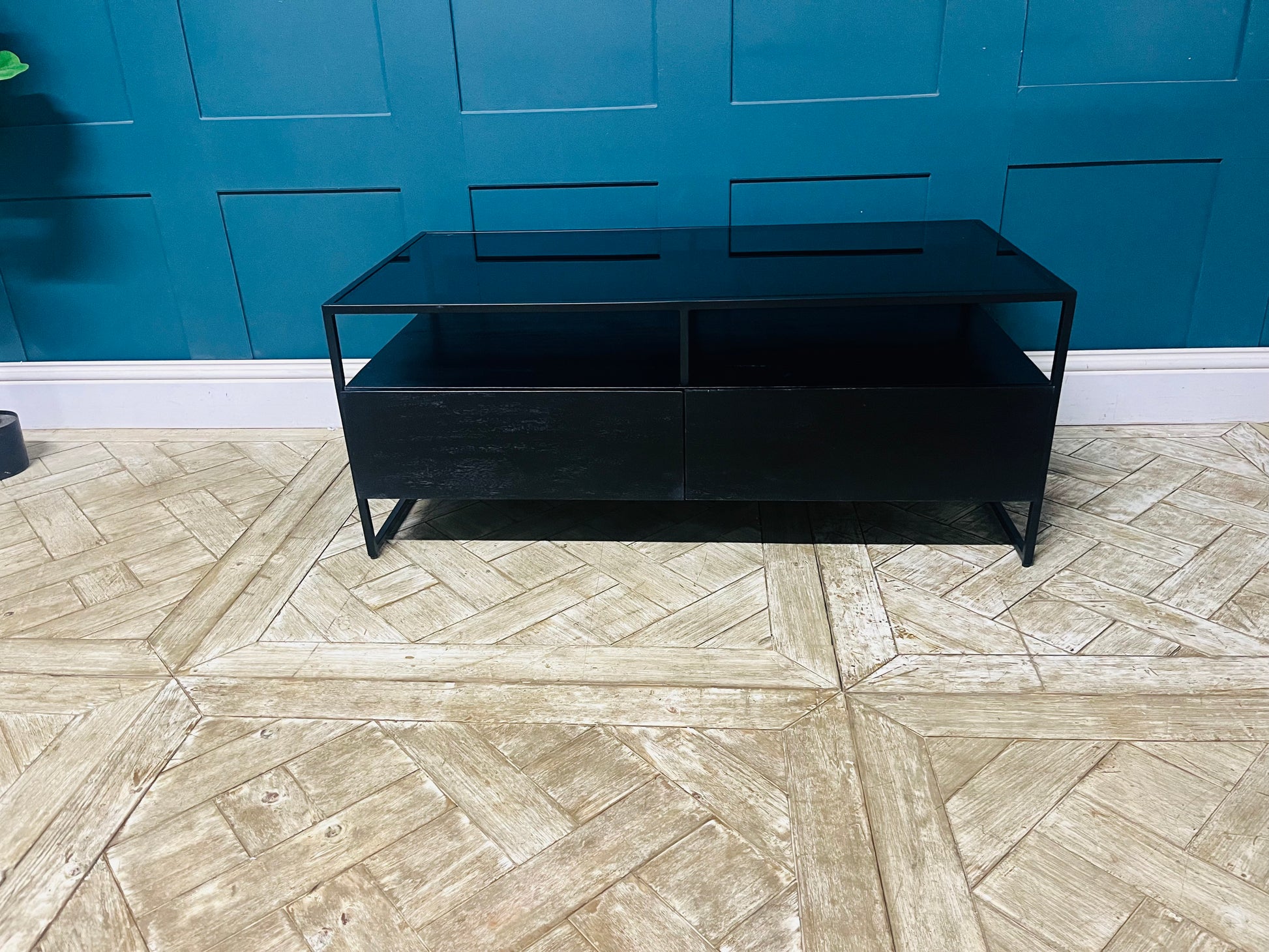 Kilby storage coffee table with two drawers, black mango wood base, and smoked glass surface. With metal frame legs