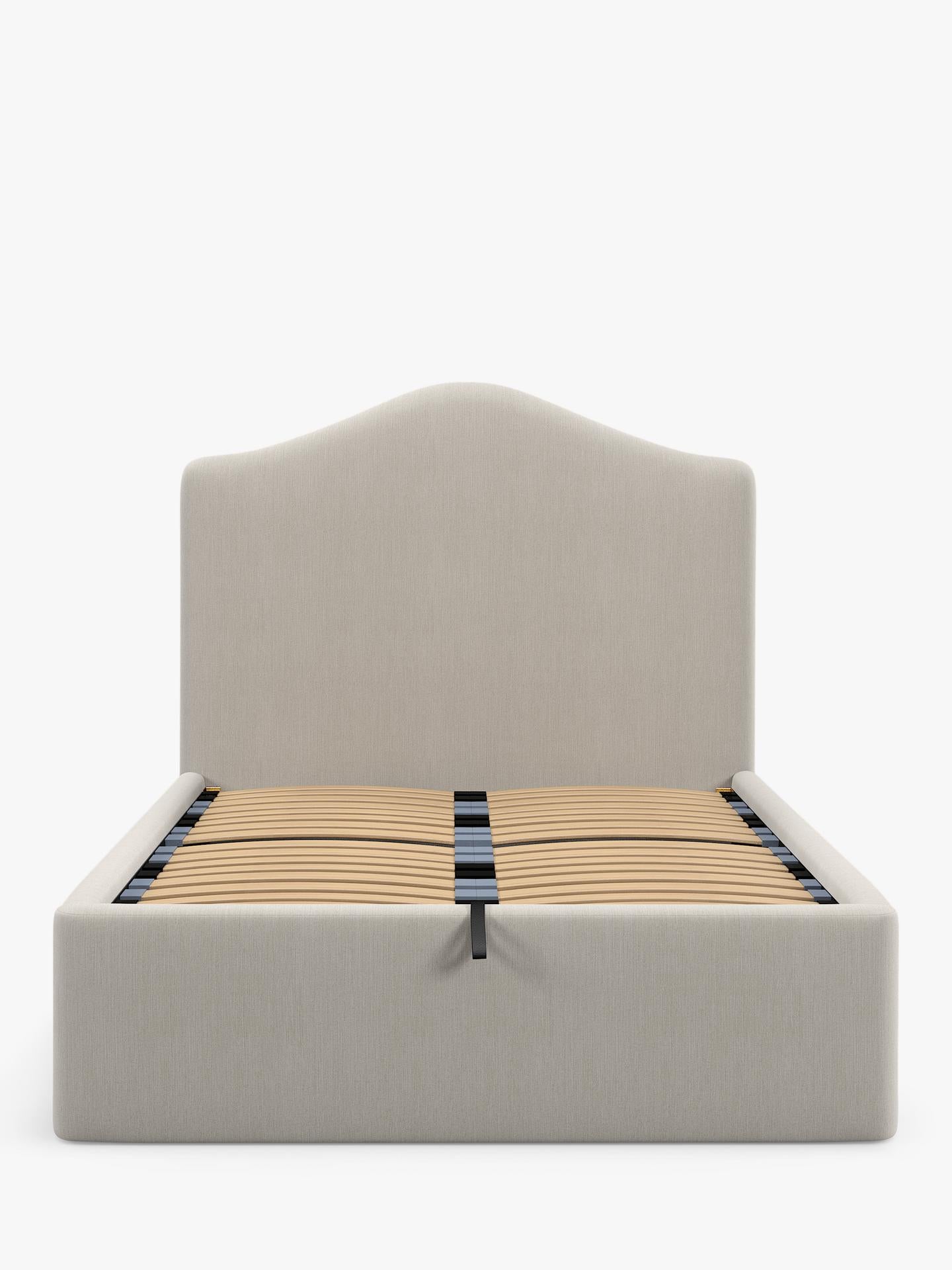 A super king size John Lewis Alice ottoman bed frame in beige cotton-effect fabric, featuring a tall button-tufted headboard and a gas-lift base opened to show the large under-bed storage area.