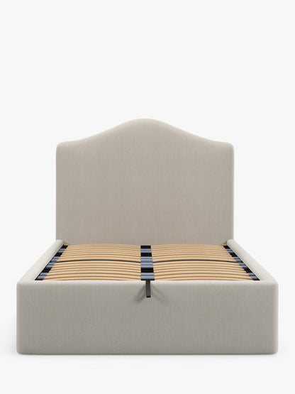 A super king size John Lewis Alice ottoman bed frame in beige cotton-effect fabric, featuring a tall button-tufted headboard and a gas-lift base opened to show the large under-bed storage area.